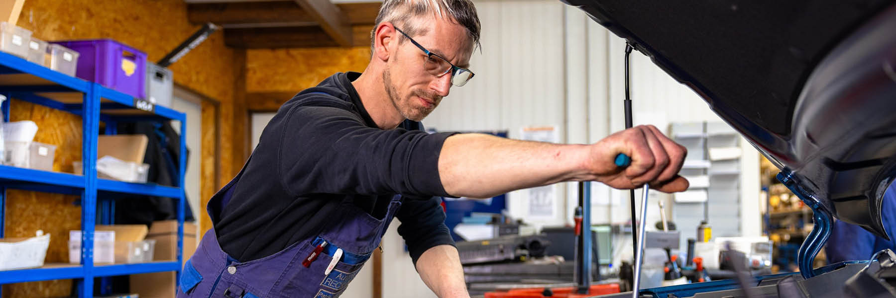 Werkstattmitarbeiter arbeitet an Motorraum